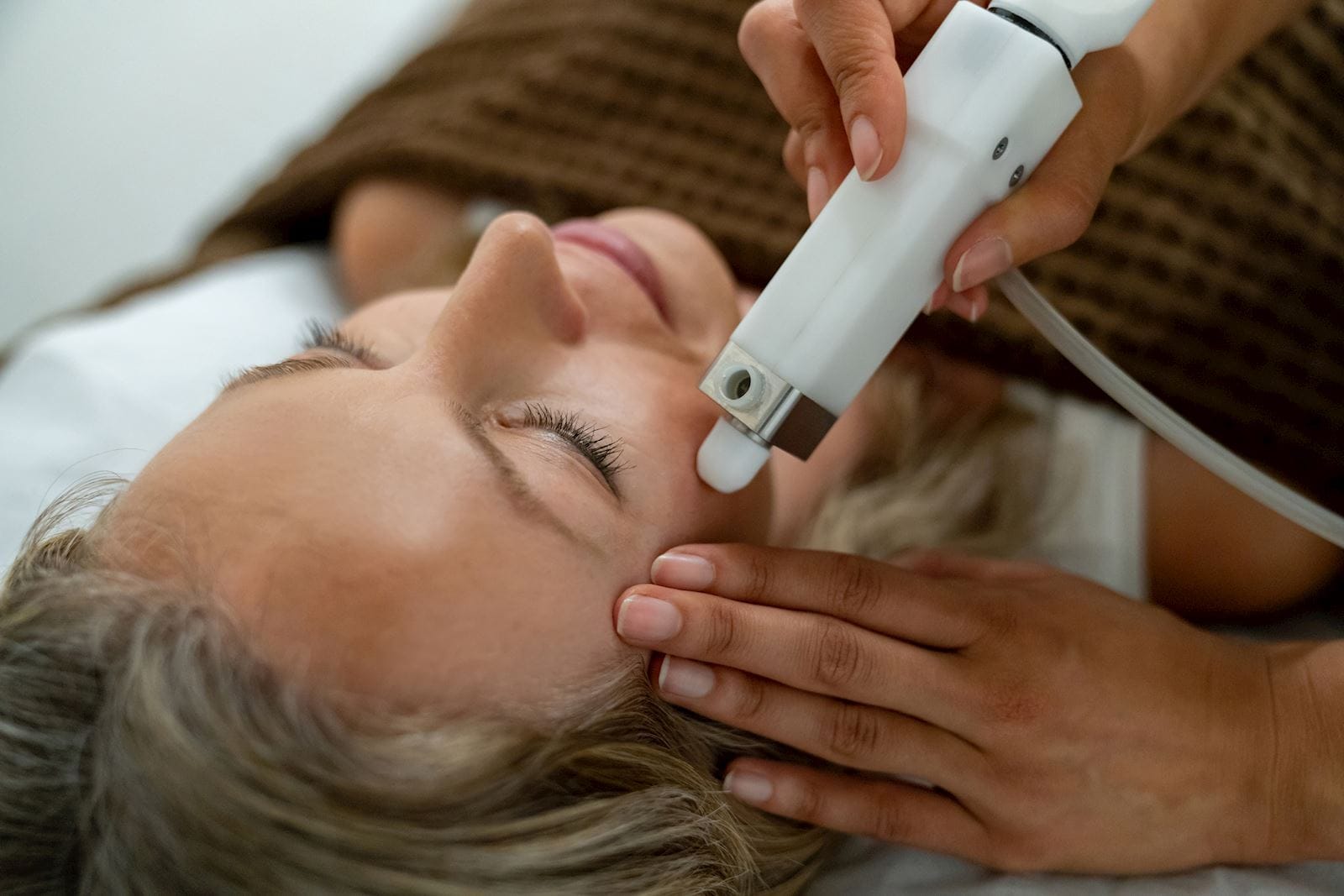 Woman getting a facial laser